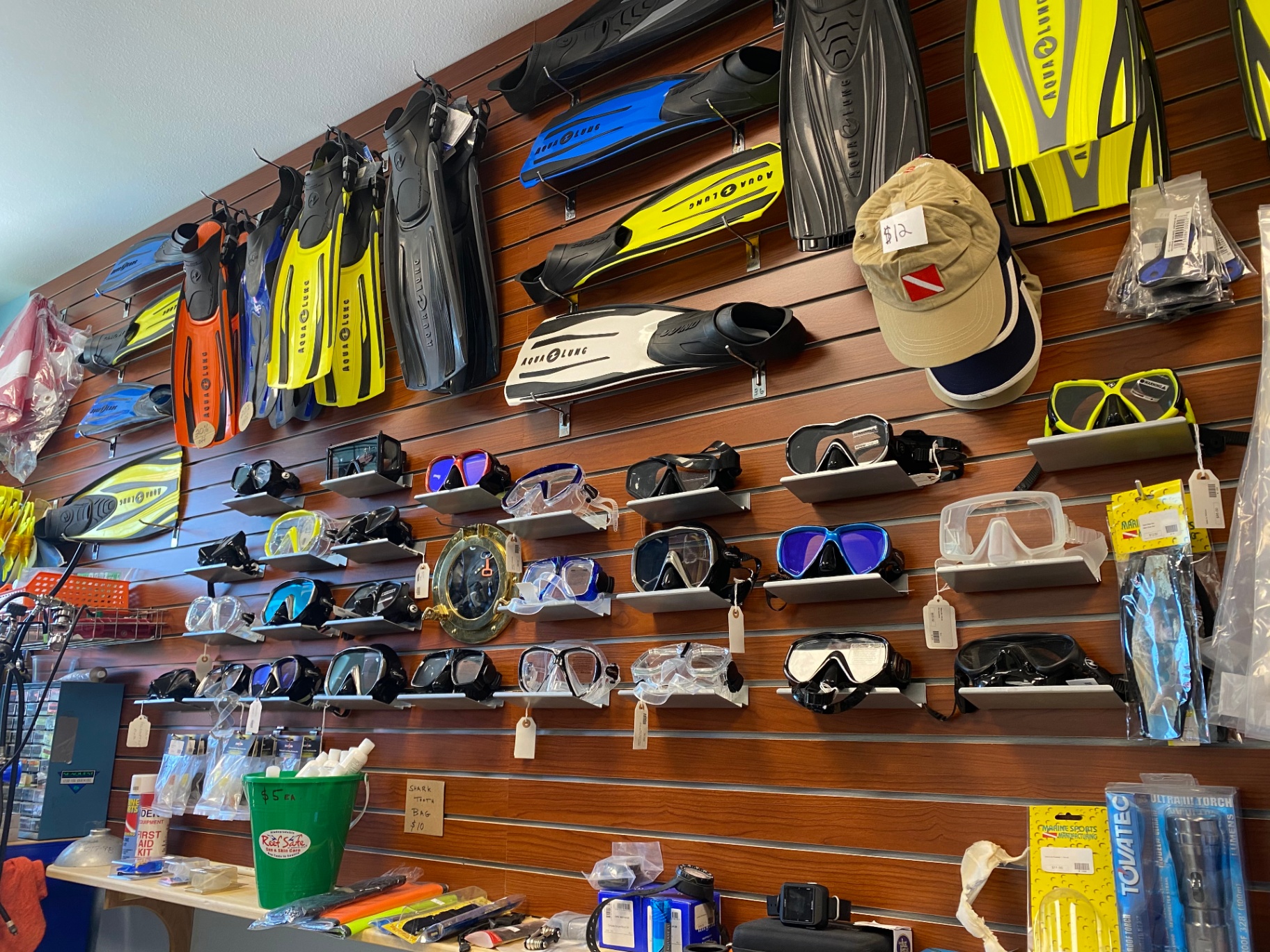 Wall of masks, fins and snorkel gear inside the shop